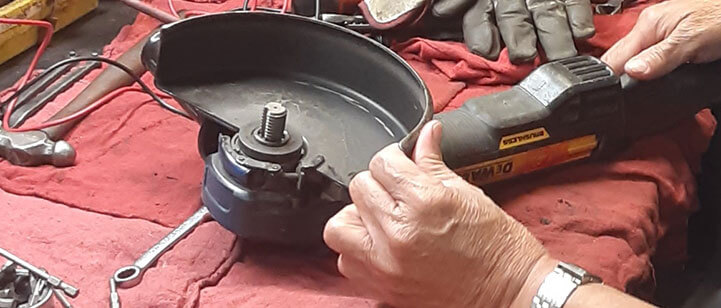 A worker repairs a broken tool.