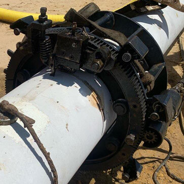 The Porta-Lathe pipe-cutting tool cutting a pipe in the field.