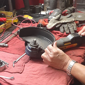 A PSS technician repairing a Saw.