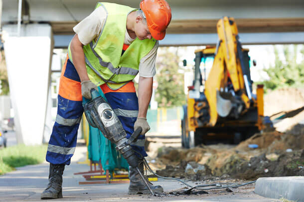 A PSS worker using a jack hammer.