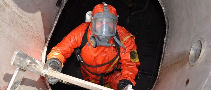 PSS employee in full PPE climbing on a ladder